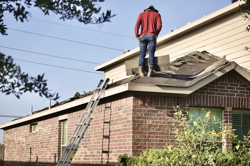 Professional roofer working on a residential roof in John Knox Village
